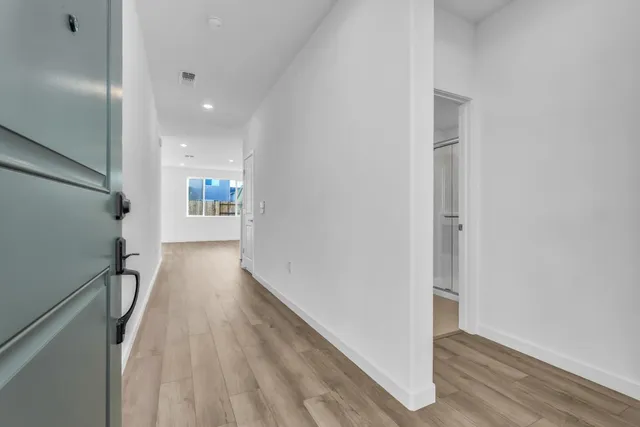 a view of hallway with wooden floor