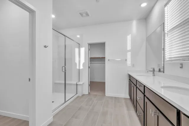 a bathroom with a double vanity sink and a mirror