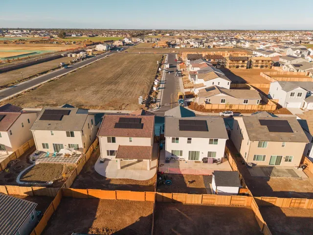 an aerial view of residential houses with outdoor space