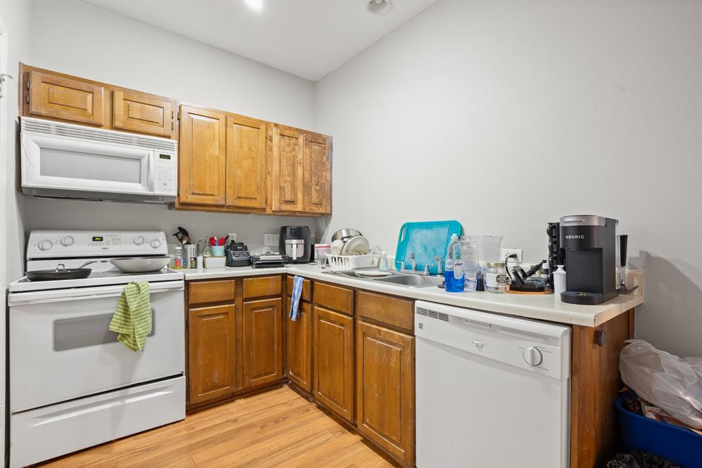 2216 San Gabriel Street, Unit 201 Austin, TX 78705 - Photo 2 of 11 a kitchen with a sink cabinets and wooden floor