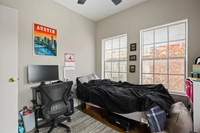 a bedroom with a bed and glass windows