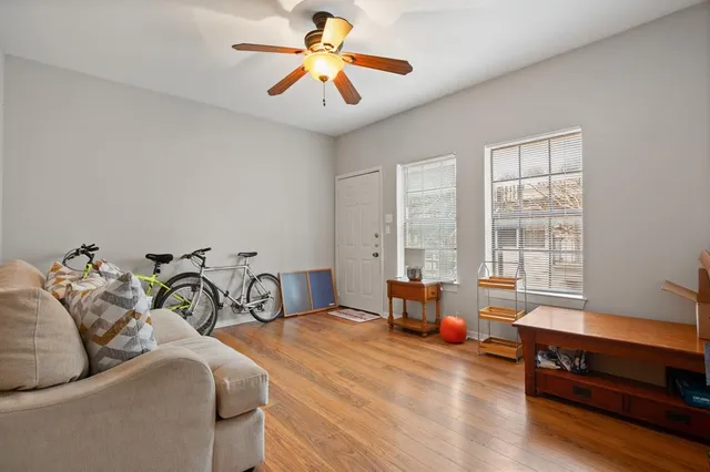 a bedroom with furniture and a large window