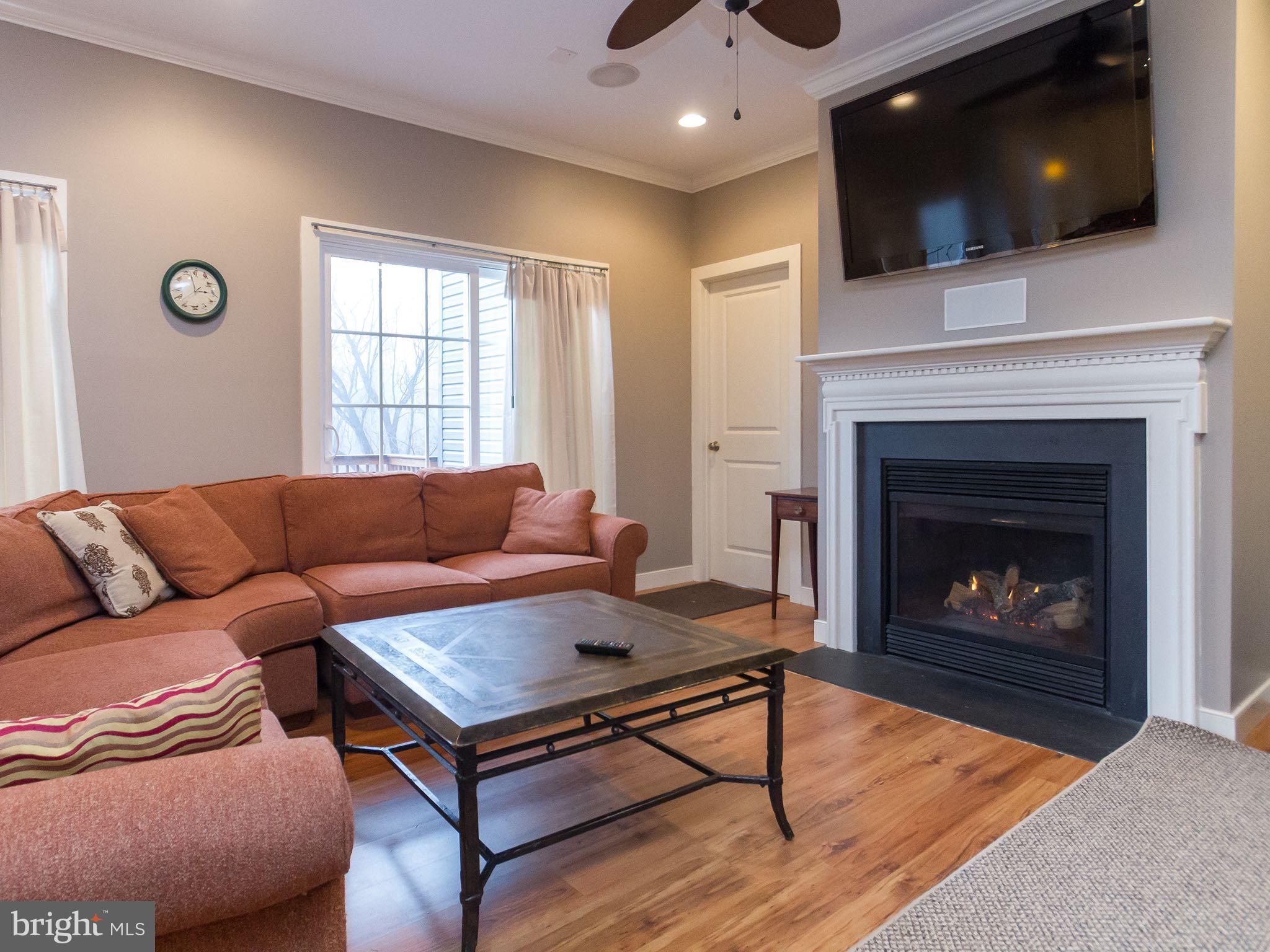 535 Monkton Road Monkton, MD 21111 - Photo 12 of 30 a living room with furniture a flat screen tv and a fireplace