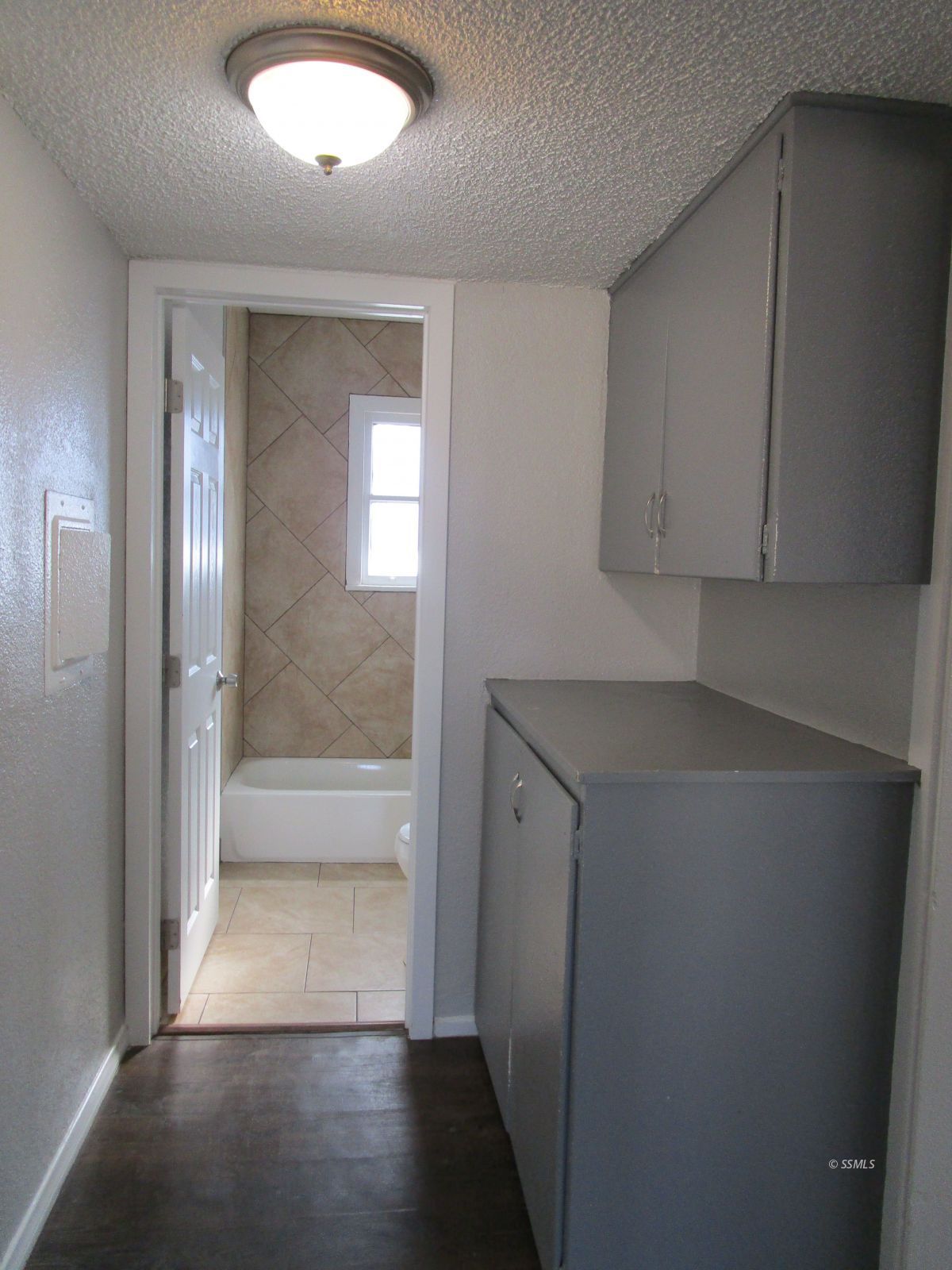 429 South Richmond Road Ridgecrest, CA 93555 - Photo 7 of 10 a view of a hallway with wooden floor and cabinet