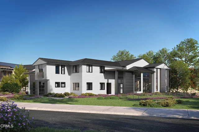 front view of a white house with a yard