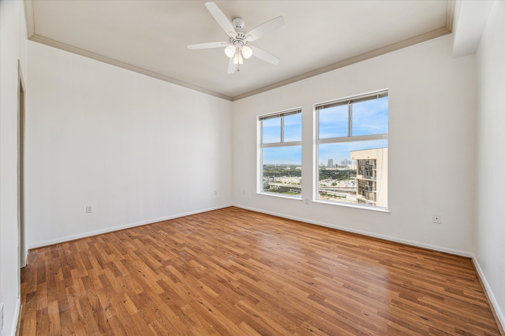3505 Sage Road, Unit 2710 Houston, TX 77056 - Photo 12 of 23 an empty room with wooden floor and windows