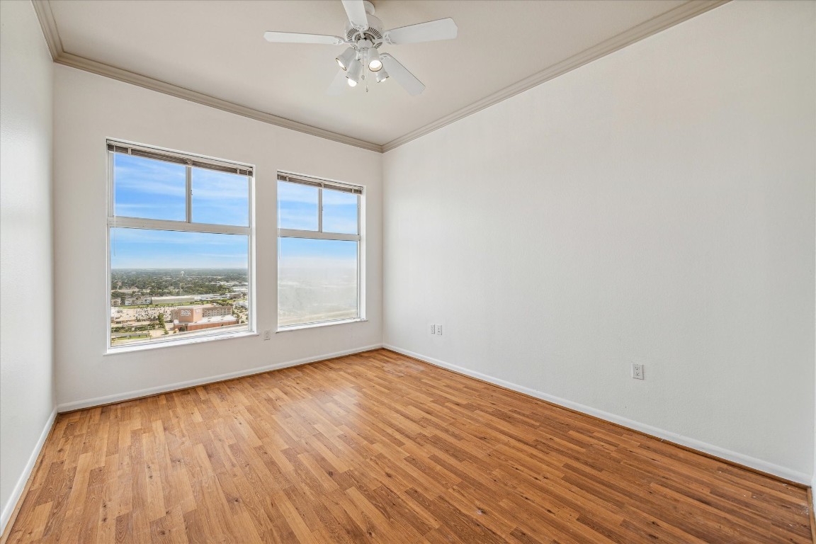 3505 Sage Road, Unit 2710 Houston, TX 77056 - Photo 15 of 23 an empty room with wooden floor fan and windows