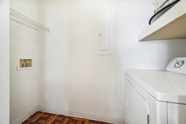 an aerial view of a pool patio outdoor seating and outdoor kitchen front of the building