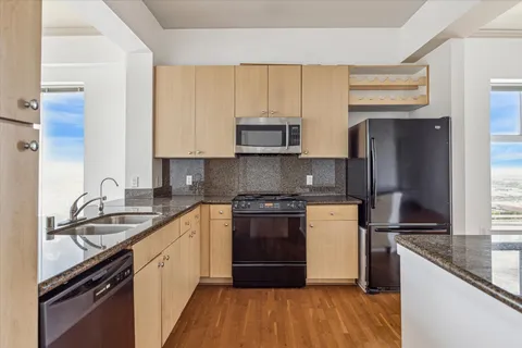 a kitchen with a sink stove top oven and cabinets