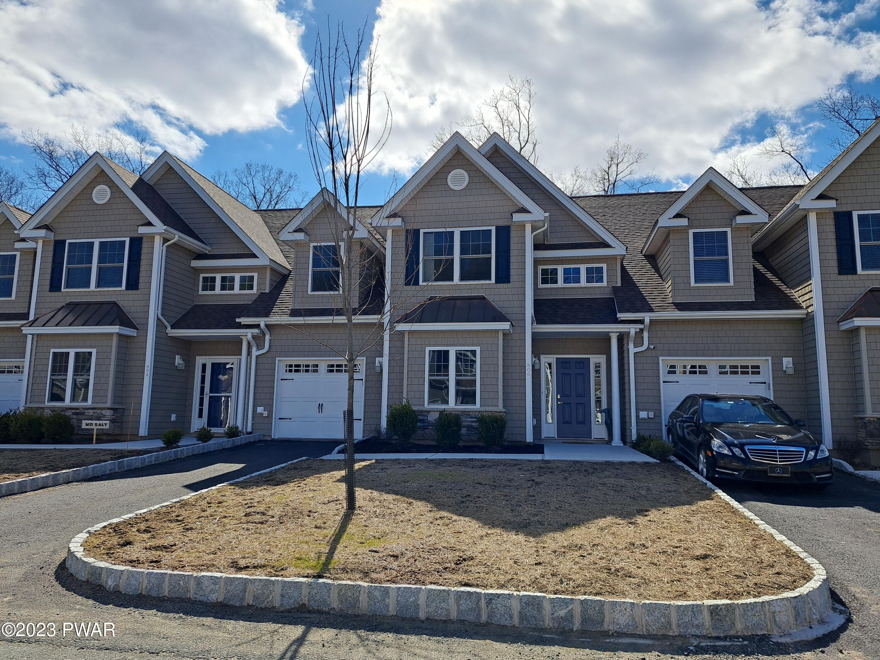 806 MacIntosh Way Matamoras, PA 18336 - Photo 1 of 53 a view of a white house with a small yard and large trees