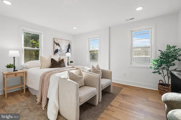 a bedroom with a bed and lamp with potted plant