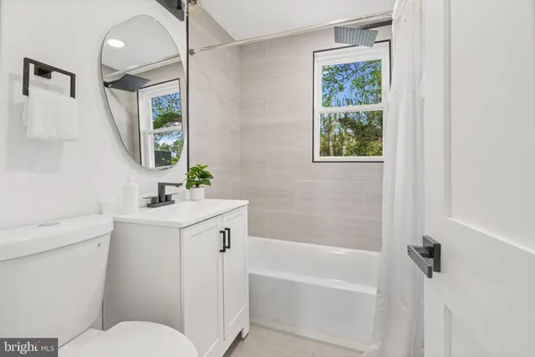 an empty room with window and closet area