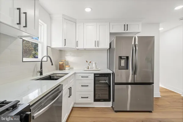 a kitchen with a sink appliances and cabinets