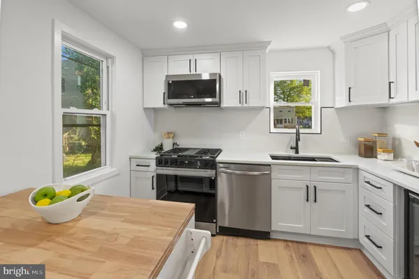 a kitchen with stainless steel appliances a stove a sink and a refrigerator