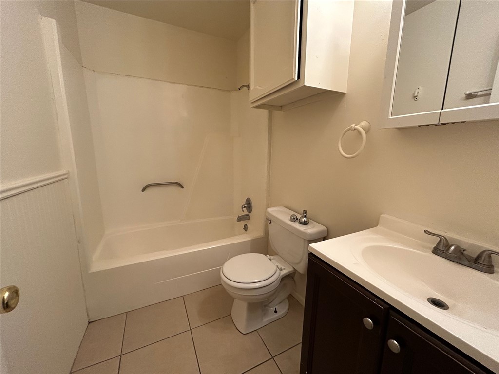 1913 Pine Tree Drive, Unit B Bryan, TX 77802 - Photo 8 of 13 a bathroom with a sink a toilet and tub