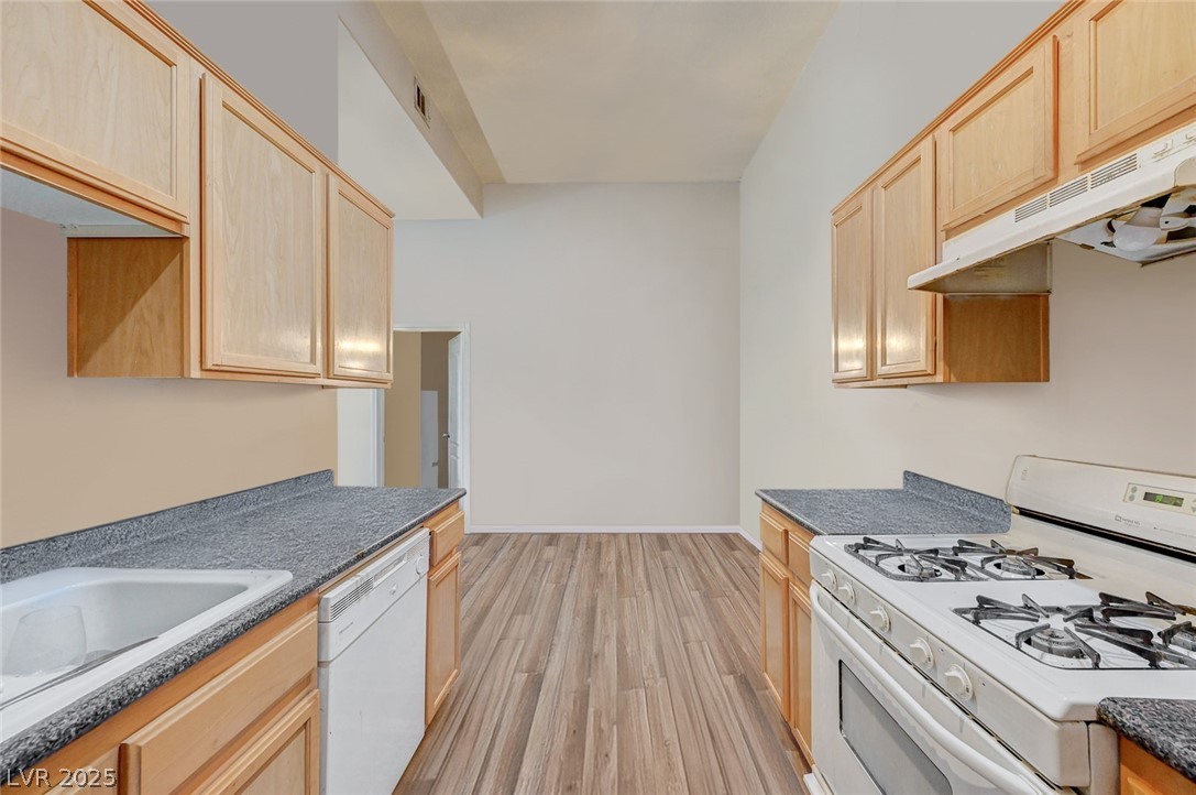 2305 West Horizon Ridge Parkway, Unit 1223 Henderson, NV 89052 - Photo 15 of 28 Kitchen with white appliances, light wood finish cabinetry, and light wood finished floors