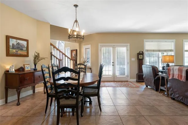 a view of a dining room with furniture and a chandelier