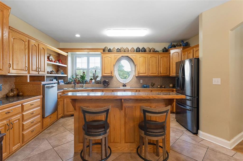 1211 Bellview Road Rockmart, GA 30153 - Photo 14 of 42 a view of a kitchen with stainless steel appliances granite countertop a stove a sink and a refrigerator