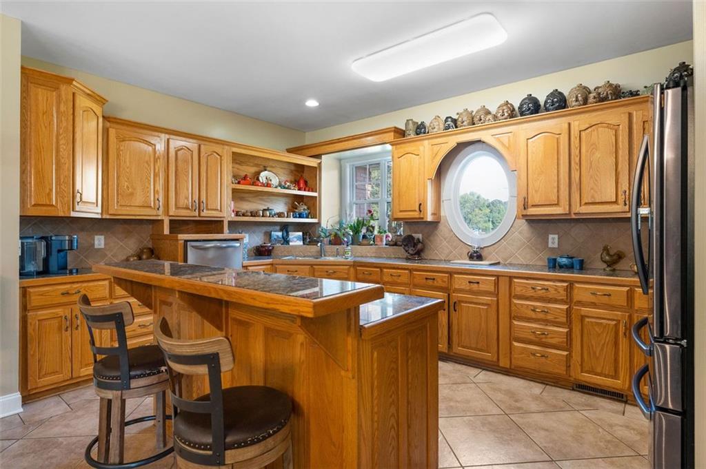 1211 Bellview Road Rockmart, GA 30153 - Photo 15 of 42 a kitchen with stainless steel appliances granite countertop a sink and a refrigerator