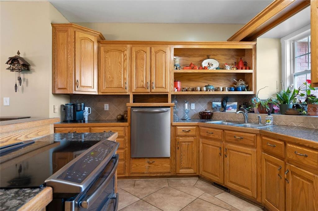 1211 Bellview Road Rockmart, GA 30153 - Photo 16 of 42 a kitchen with stainless steel appliances granite countertop a stove a sink and a microwave