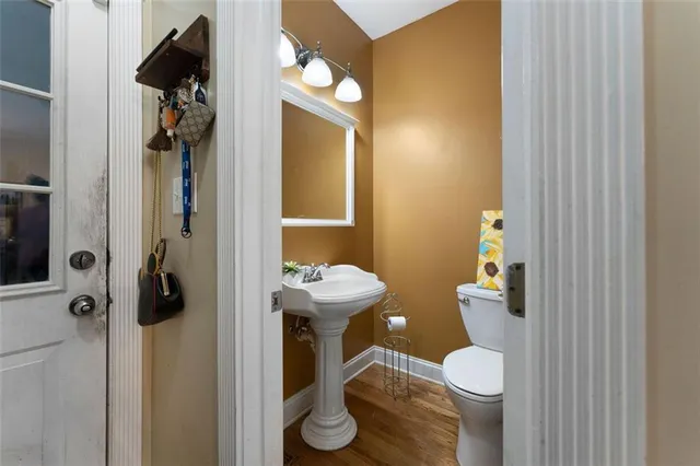 a bathroom with a toilet and a mirror