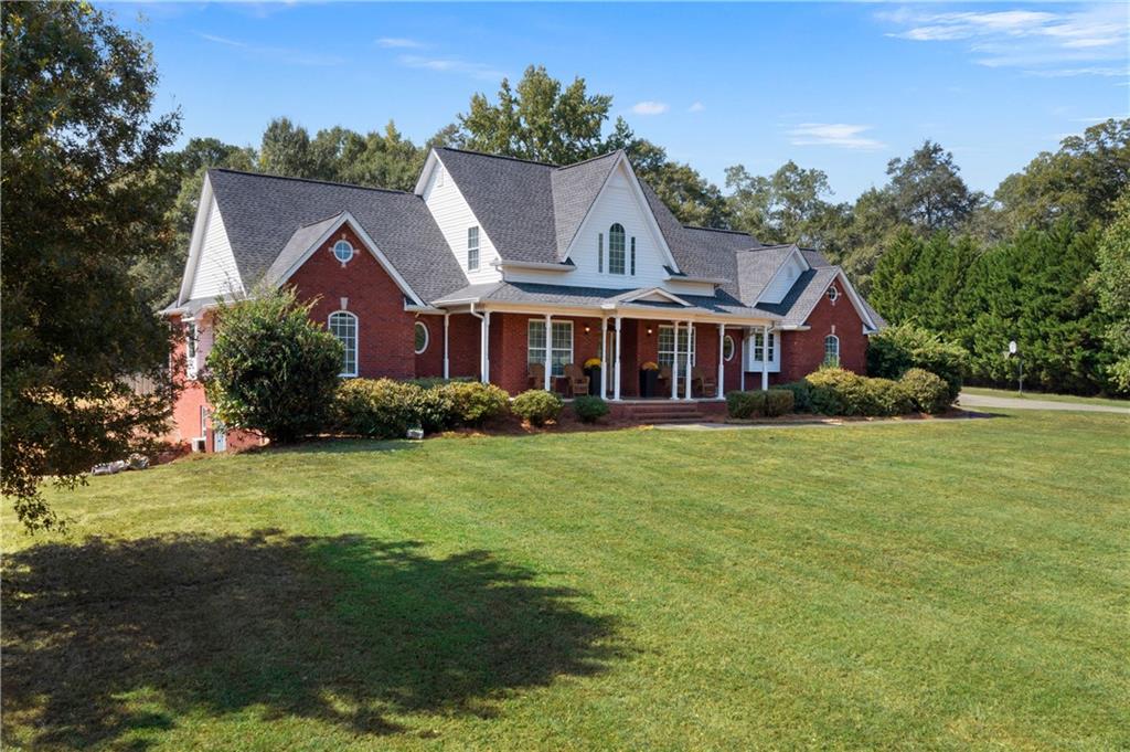 1211 Bellview Road Rockmart, GA 30153 - Photo 2 of 42 a front view of house with yard and trees in the background