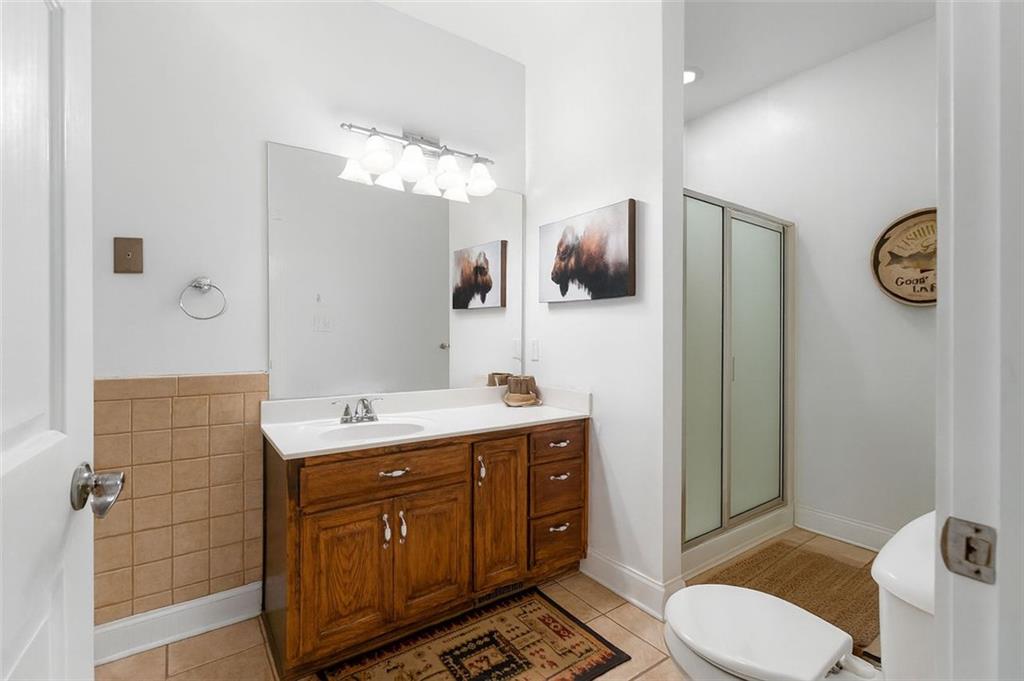 1211 Bellview Road Rockmart, GA 30153 - Photo 21 of 42 a spacious bathroom with a granite countertop toilet sink and mirror