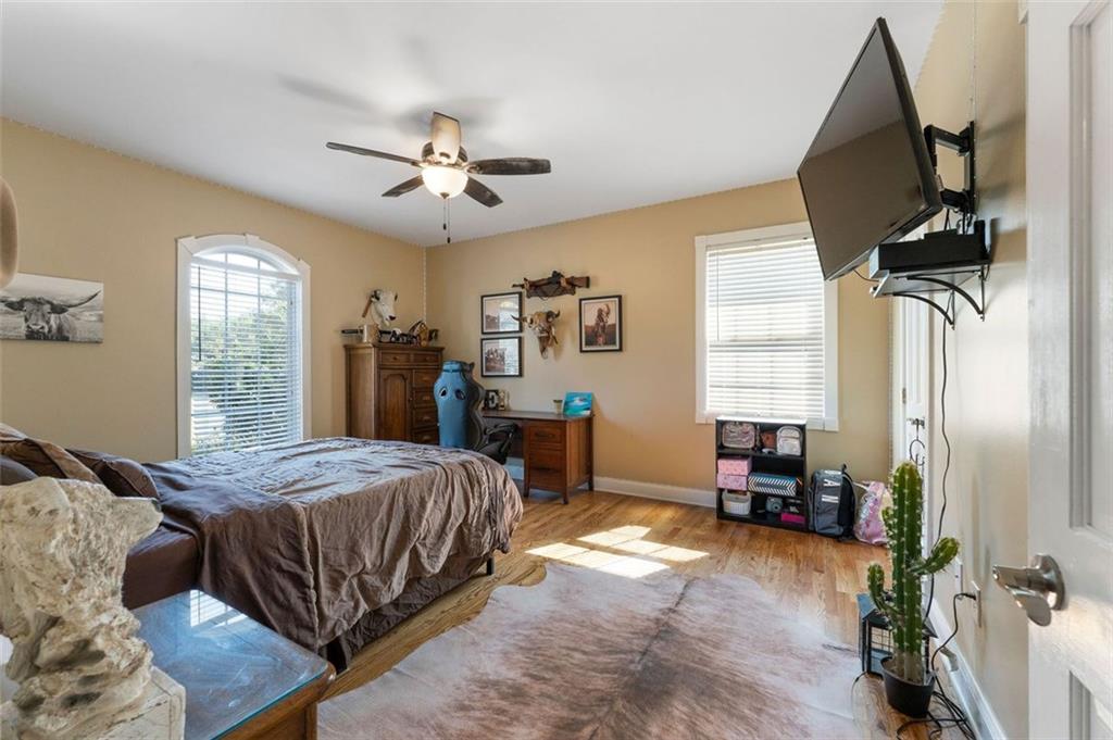 1211 Bellview Road Rockmart, GA 30153 - Photo 23 of 42 a bedroom with a bed and a chandelier