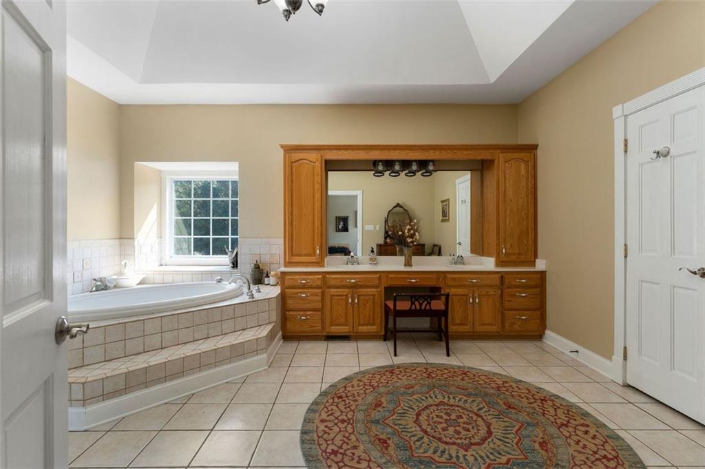1211 Bellview Road Rockmart, GA 30153 - Photo 25 of 42 a spacious bathroom with a tub sink and mirror
