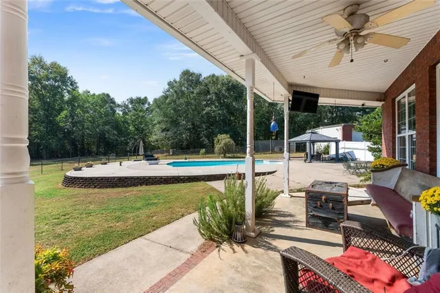 a view of a swimming pool with a patio