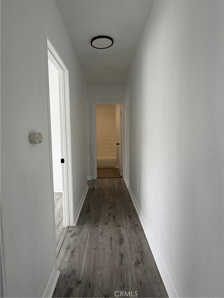 304 West Cedar Street Compton, CA 90220 - Photo 6 of 9 a view of a hallway with wooden floor
