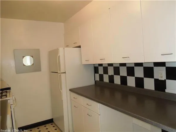 a kitchen with granite countertop a sink and cabinets