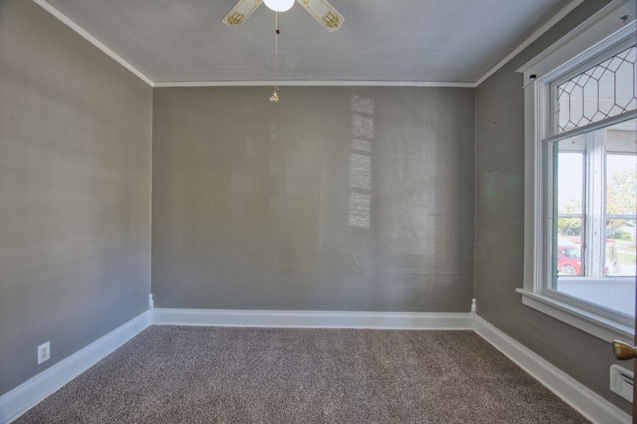 25 3rd Street Southwest Chisholm, MN 55719 - Photo 13 of 44 Carpeted spare room with ornamental molding and ceiling fan