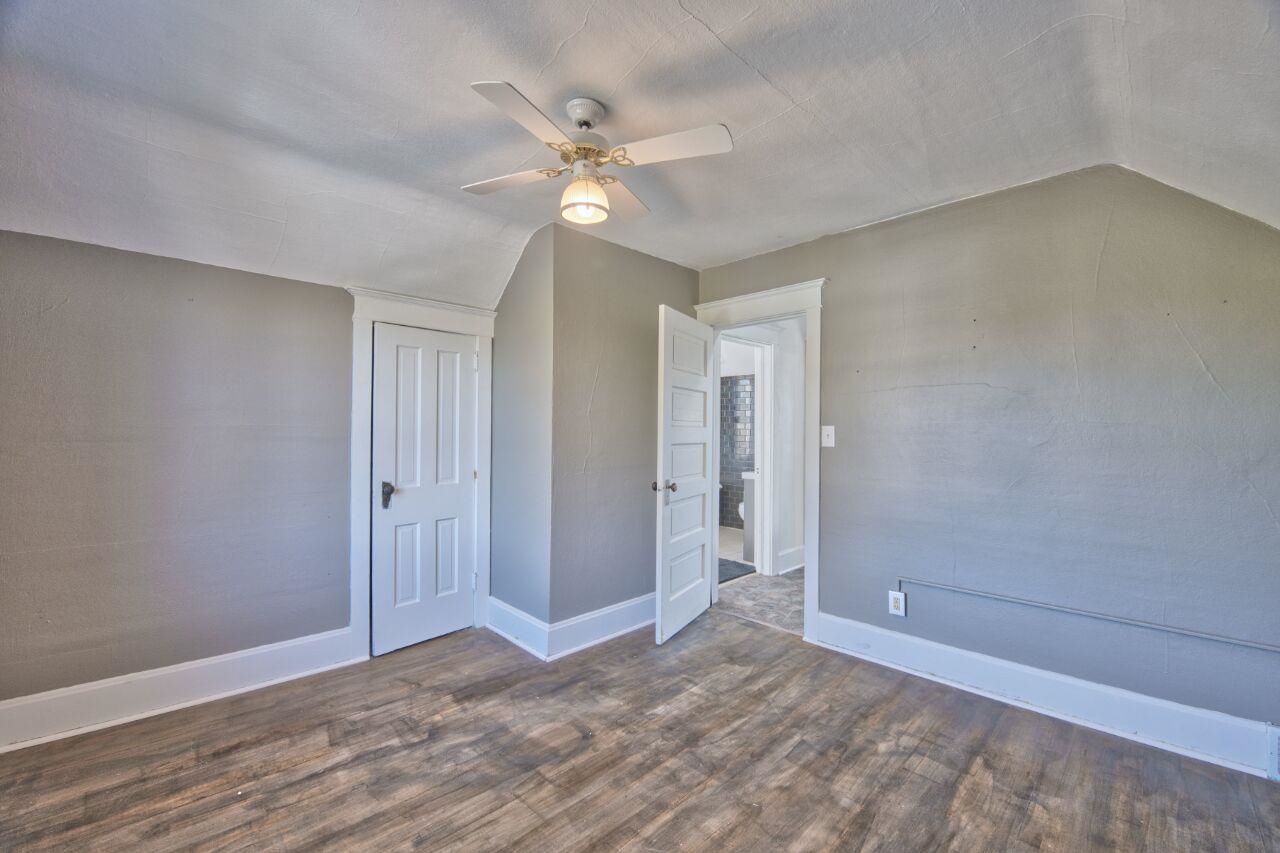 25 3rd Street Southwest Chisholm, MN 55719 - Photo 16 of 44 Unfurnished bedroom featuring lofted ceiling, dark wood finished floors, a closet, and ceiling fan