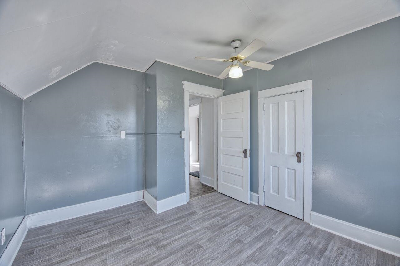 25 3rd Street Southwest Chisholm, MN 55719 - Photo 18 of 44 Unfurnished bedroom with wood finished floors, a ceiling fan, and lofted ceiling