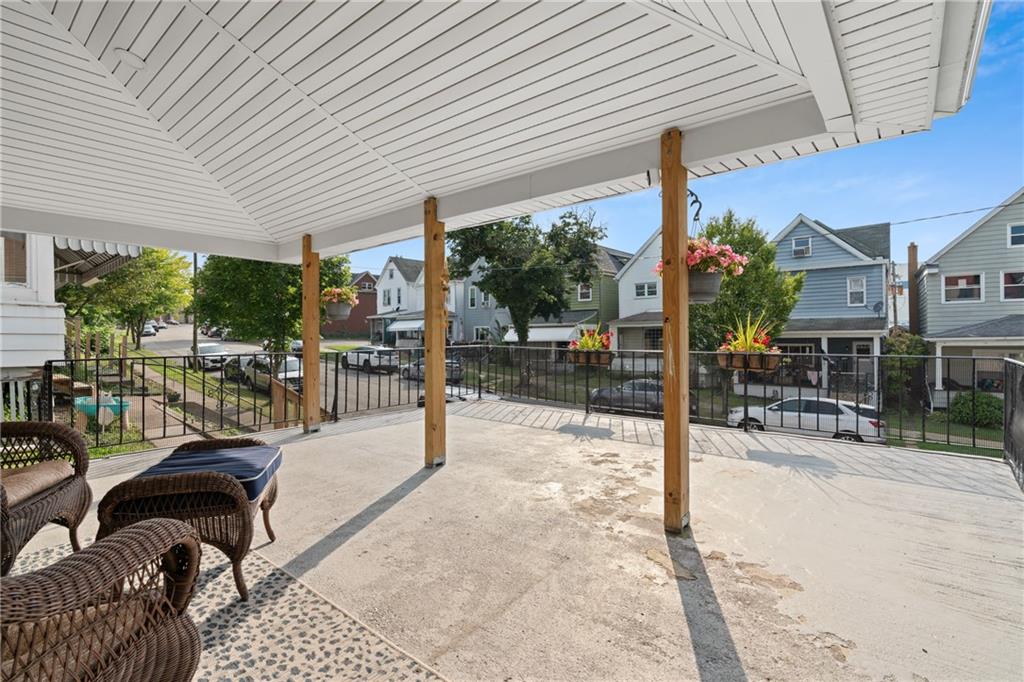 107 Sumner Avenue Vandergrift, PA 15690 - Photo 23 of 31 a view of a patio with table and chairs potted plants and floor to ceiling window