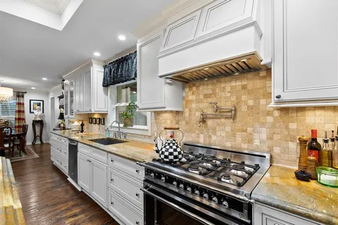 a living room with furniture kitchen view and a large window