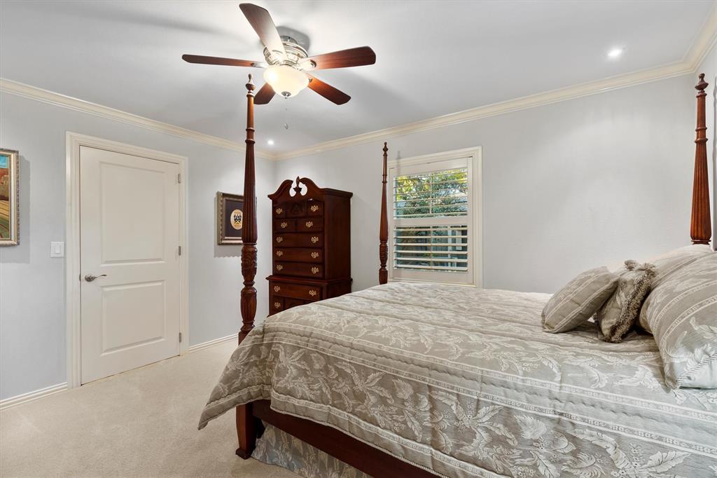 1432 Sylvan Avenue Dallas, TX 75208 - Photo 24 of 40 a bedroom with a bed and a chandelier