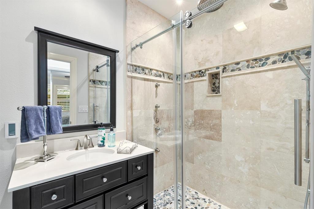 1432 Sylvan Avenue Dallas, TX 75208 - Photo 25 of 40 a bathroom with a double vanity sink mirror and shower