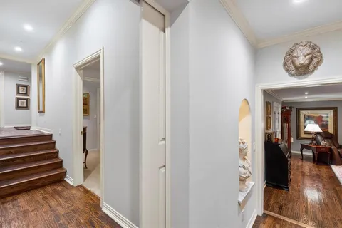 a bedroom with a bed tv and a chair