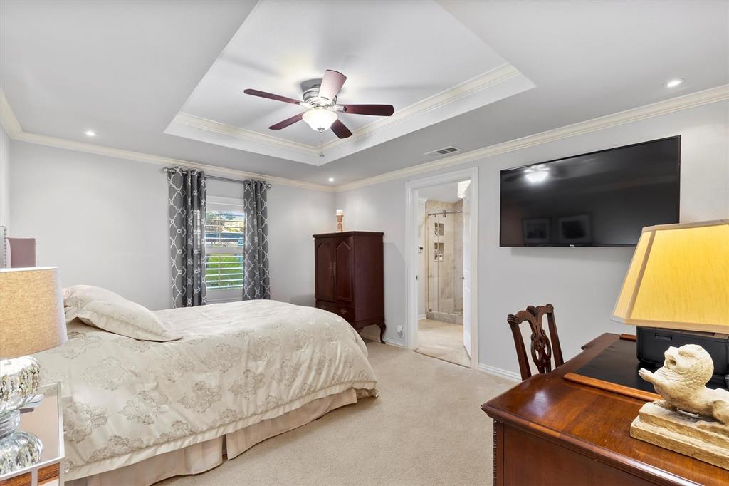 1432 Sylvan Avenue Dallas, TX 75208 - Photo 27 of 40 a bedroom with a bed tv and a chair