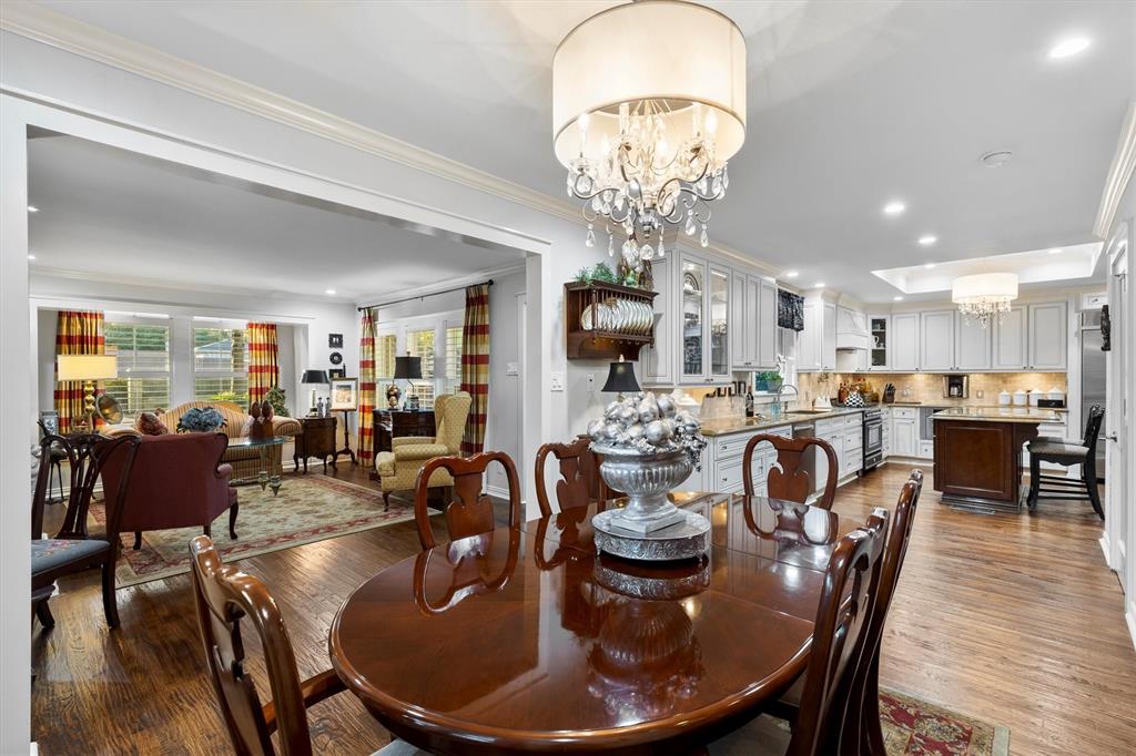 1432 Sylvan Avenue Dallas, TX 75208 - Photo 9 of 40 a dining room with furniture a kitchen and chandelier
