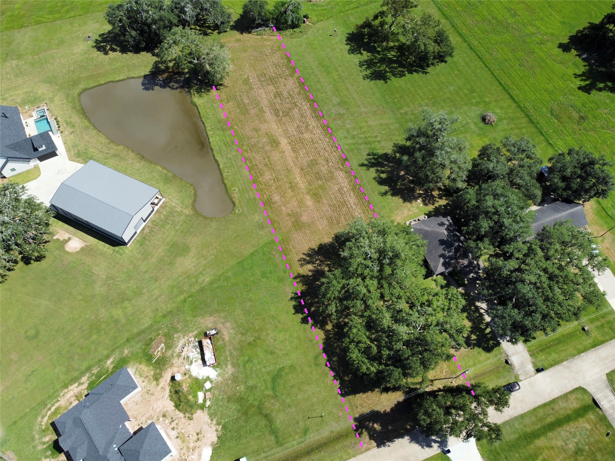an aerial view of residential house with pool and garden