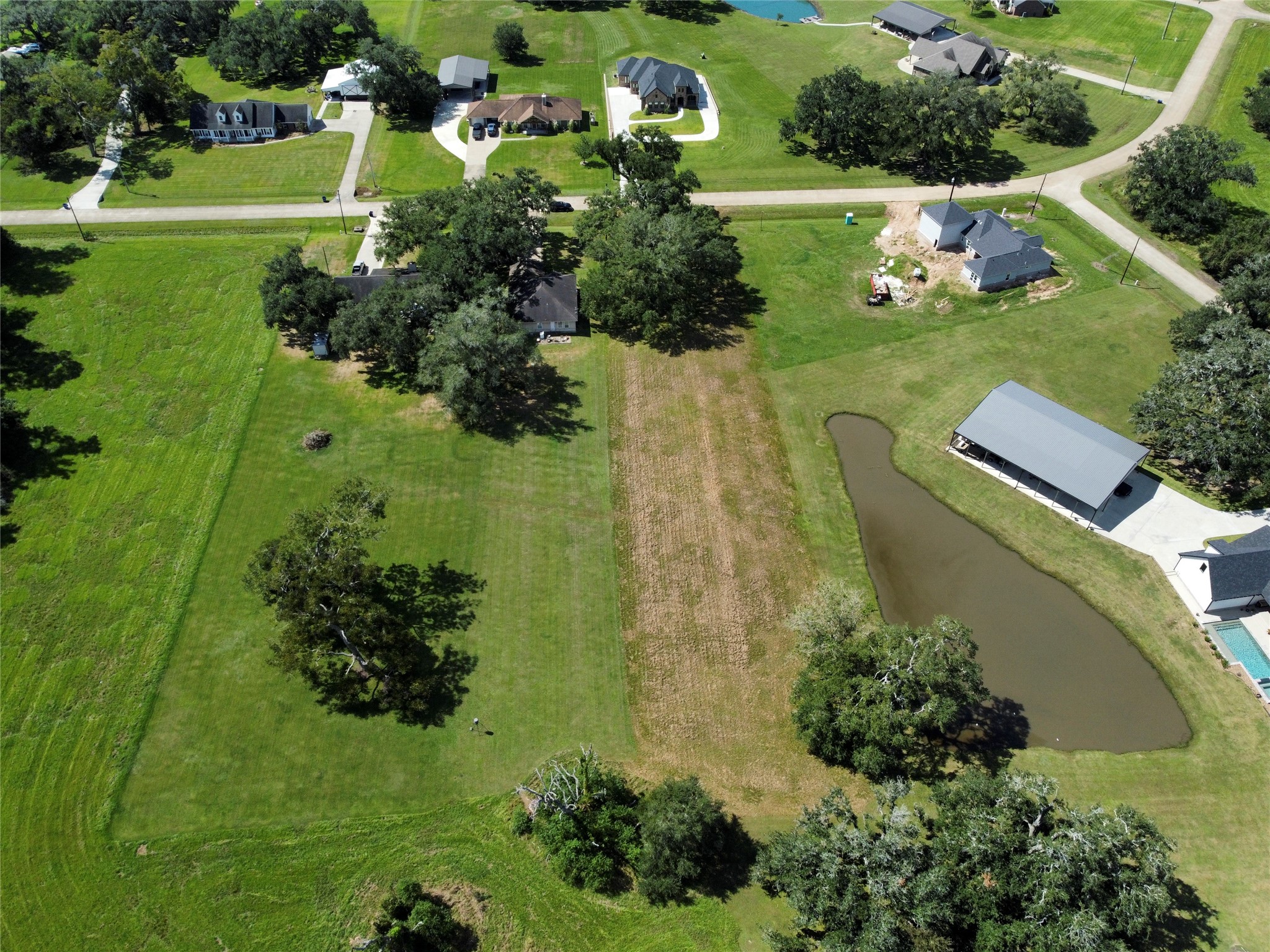 158 Cattle Drive Trail Angleton, TX 77515 - Photo 12 of 18 a view of a lake with a yard