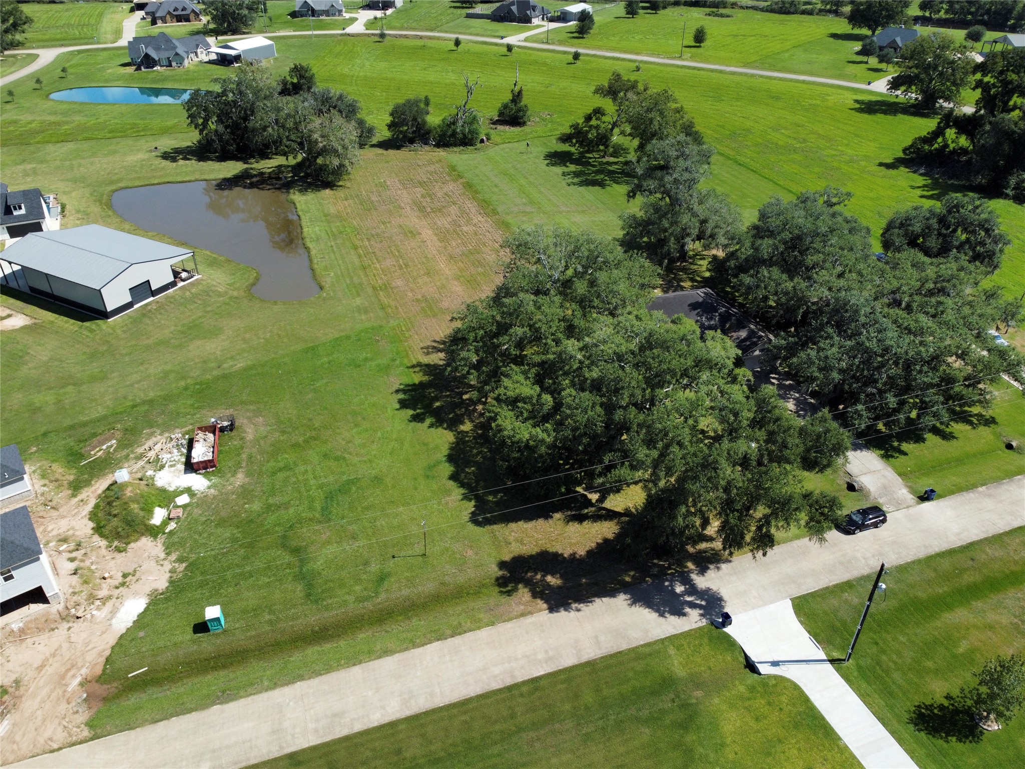 158 Cattle Drive Trail Angleton, TX 77515 - Photo 2 of 18 a view of a golf course with a lake