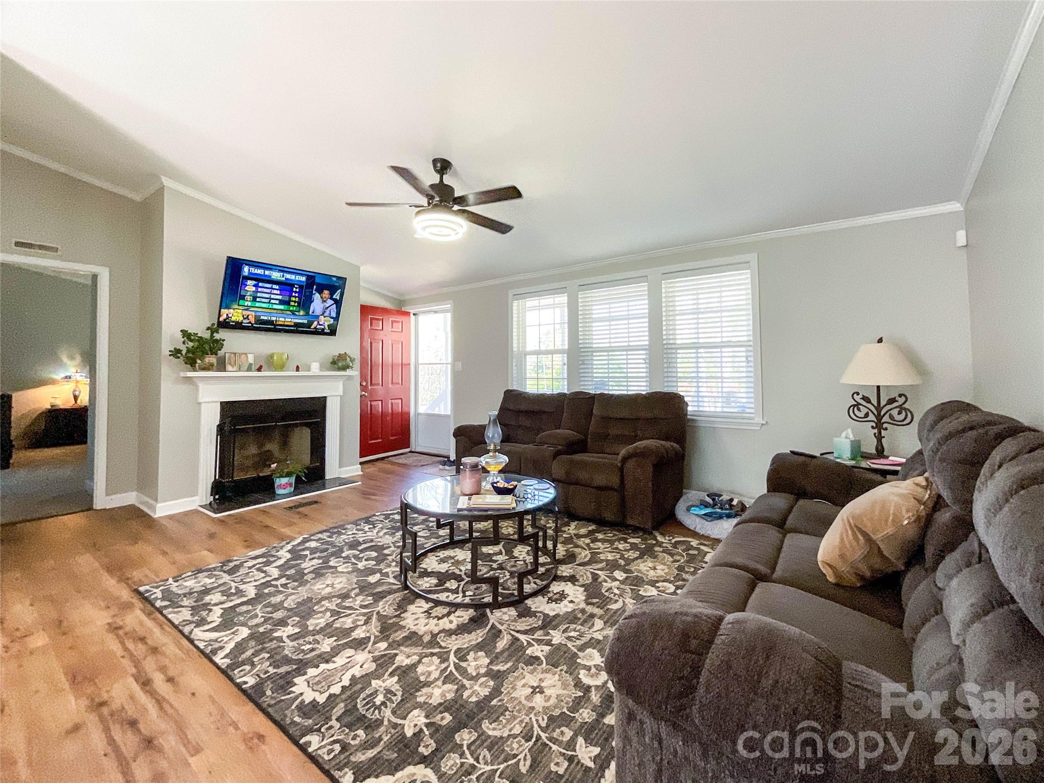 7706 Davis Road Waxhaw, NC 28173 - Photo 12 of 45 a living room with furniture a fireplace and a flat screen tv