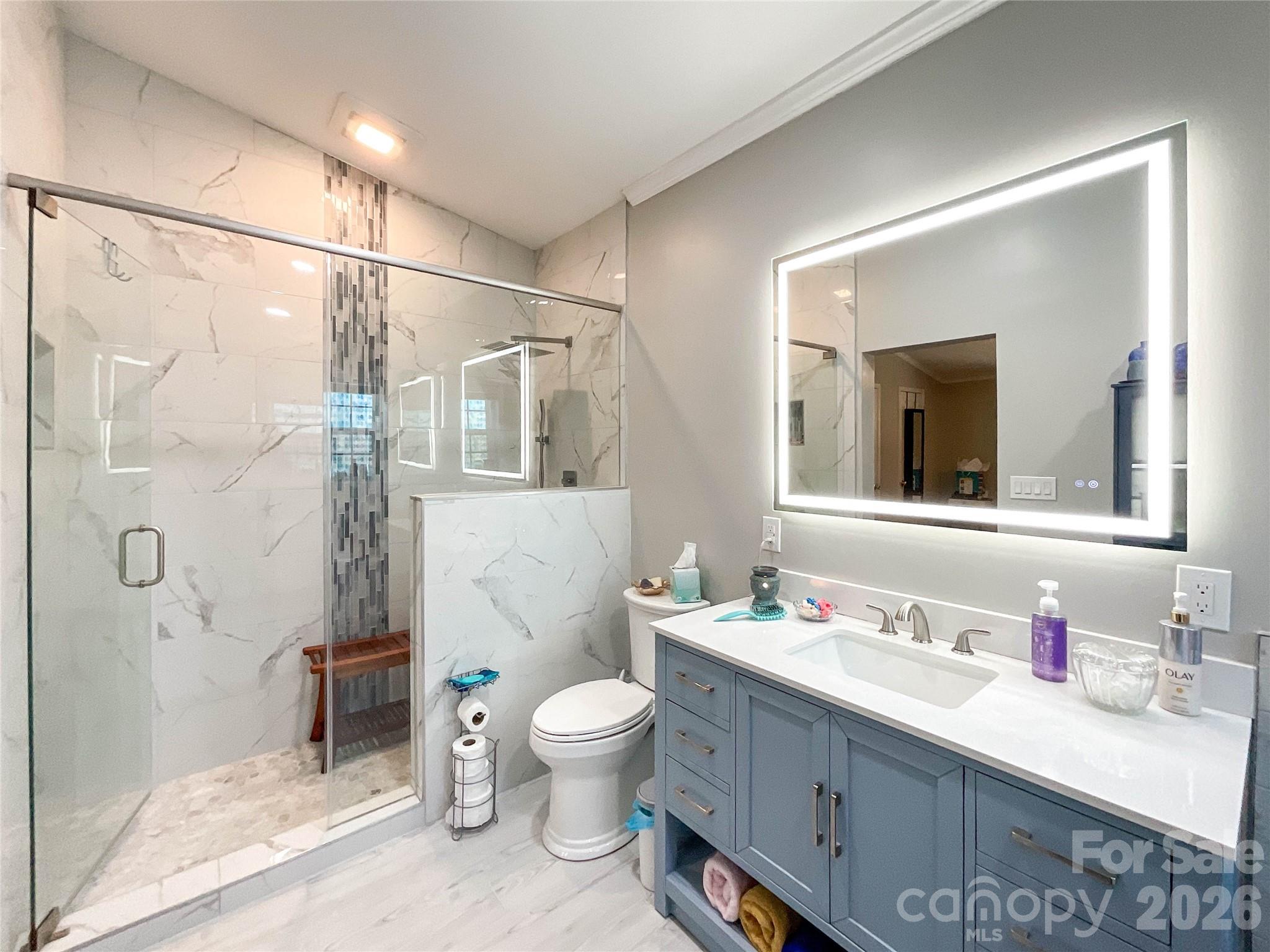 7706 Davis Road Waxhaw, NC 28173 - Photo 16 of 45 a bathroom with a double vanity sink toilet mirror and shower