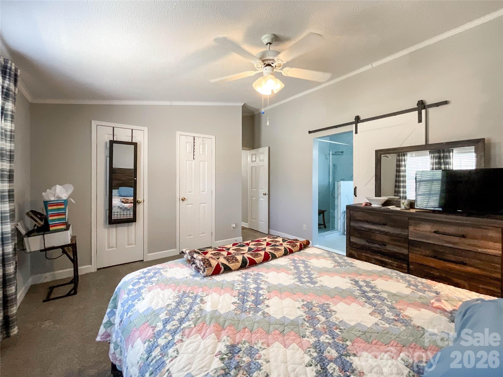 7706 Davis Road Waxhaw, NC 28173 - Photo 19 of 45 a bedroom with a bed and a chandelier