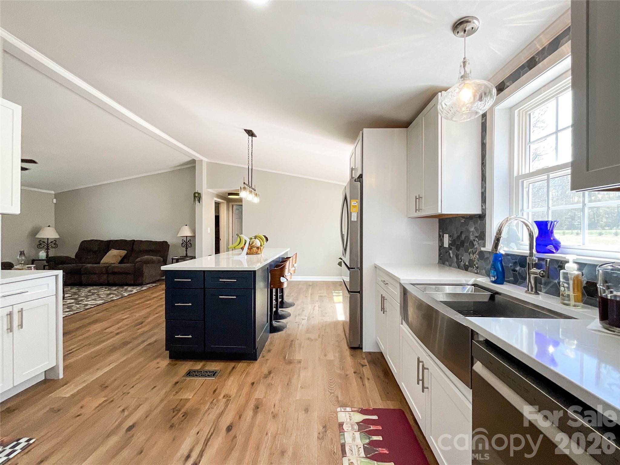7706 Davis Road Waxhaw, NC 28173 - Photo 6 of 45 a kitchen with stainless steel appliances granite countertop a sink stove and wooden cabinets