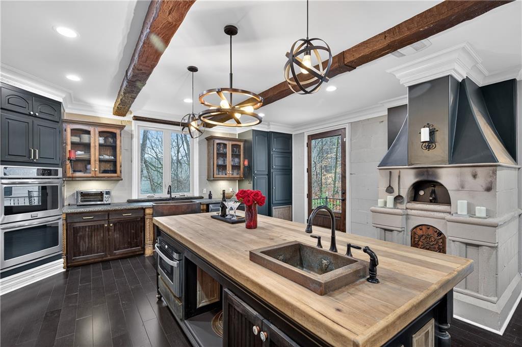 745 Goshen Road Thomaston, GA 30286 - Photo 11 of 41 a kitchen with a stove a sink dishwasher a kitchen island with wooden cabinets and floor